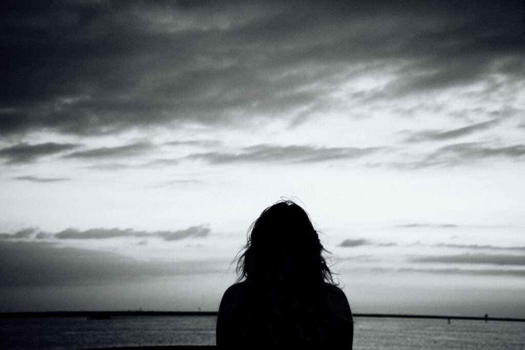 Suicidal contemplation and wellness advice - Woman and Grey Sea